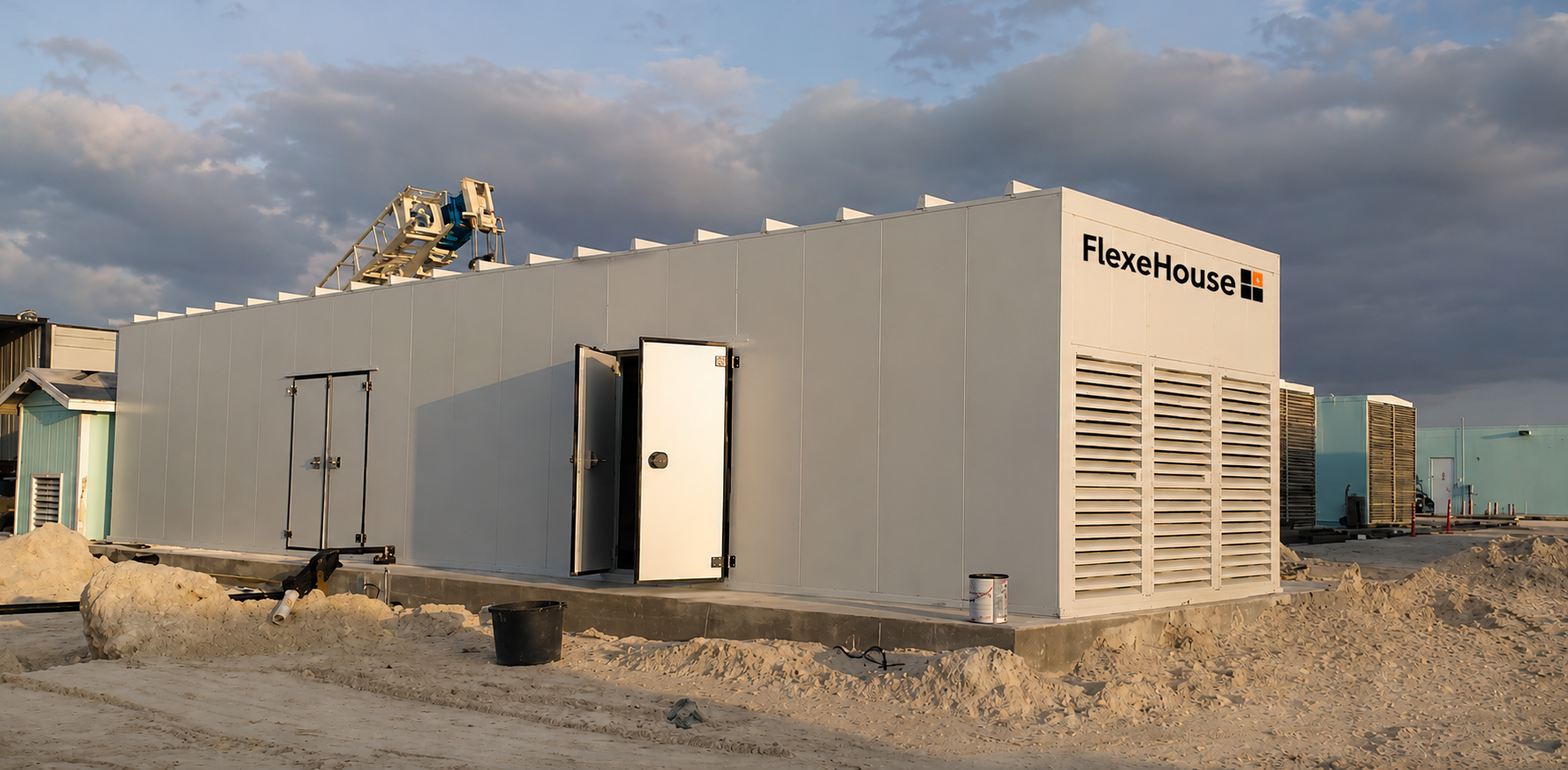FlexeHouse on site — louvred ventilation and access doors deployed in desert conditions.