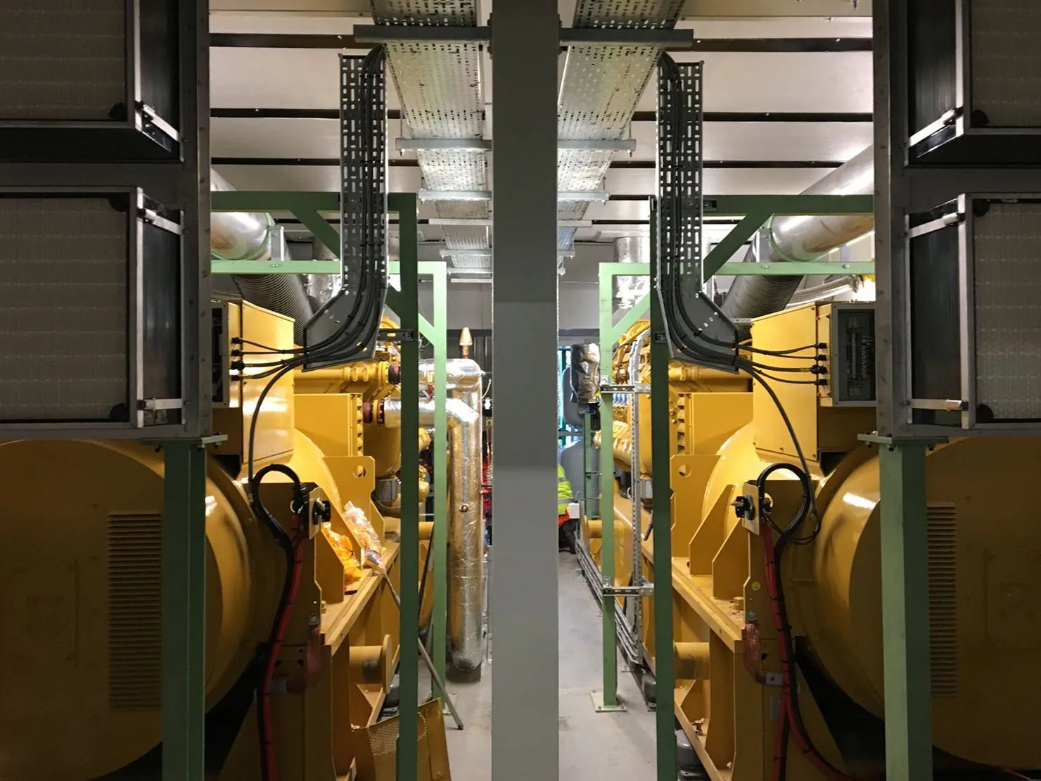 Interior view — twin engines with cable trays, exhaust runs and service access.