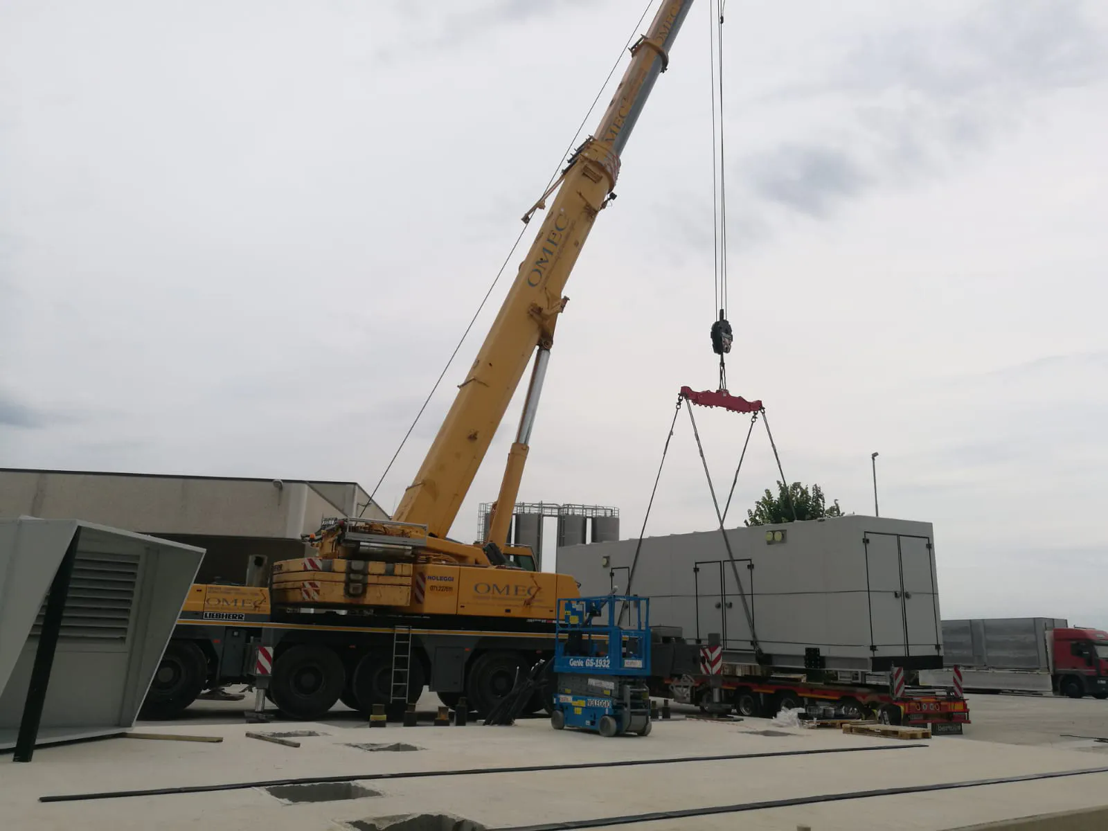 FlexEgen gas CHP module craned into position — single-lift install of a fully pre-assembled gas engine combined heat and power package.